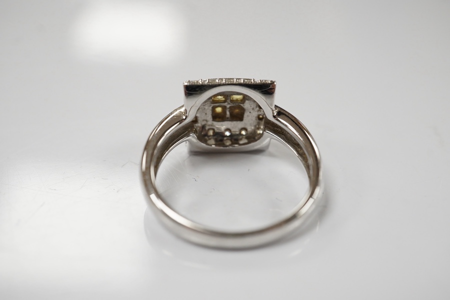 A modern 18ct white gold, yellow sapphire and diamond chip set square cluster ring, size N/O, gross weight 5.1 grams. Condition - fair to good